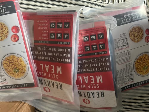 Reviewer's image shows several Self Heating Kits lined up in their red and white packaging.