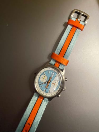 Customer's blue and orange Alpha2 Racing Stripe band attached to a watch with a matching light blue and orange face.