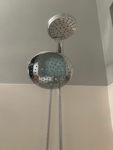 Customer's installed chrome 3-Spray Dual Shower Head Set against a light-colored wall.