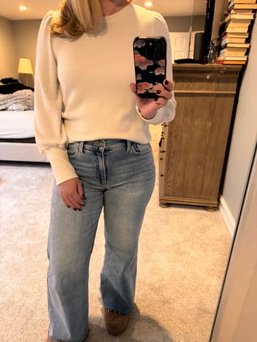 Reviewer taking a mirror selfie in the cream Quiet Confidence Sweater, worn with light-wash jeans.