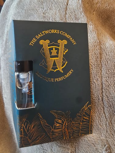 Customer's sample vial of Honeyberry perfume in its dark green and gold packaging.