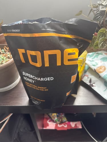 Customer's opened black pouch of SuperCharged Honey sitting on a shelf.