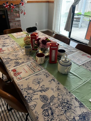 Customer's dining table set for the Bake Off Murder Mystery Game, with character booklets and British-themed decorations.