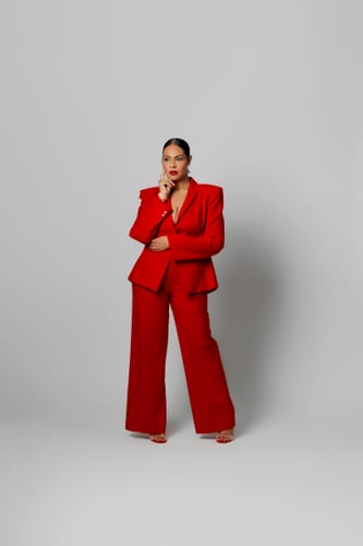 Reviewer posing in the vibrant red Suiting Seam Wideleg Pants and matching blazer.