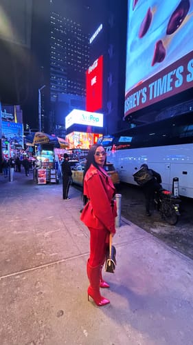 Reviewer in the red Vegan Leather Cropped Trench Jacket, noting the big shoulders.