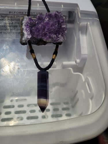 Customer's Amethyst Crystal Cluster hanging on a black cord above another crystal pendant.