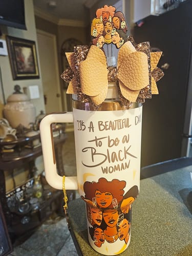 Reviewer's personalized "Crème Brûlée" tumbler, shown with a large bow and a matching straw topper.