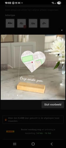 Rezensent zeigt eine Vorschau der „Ons evenement“-Acrylplatte mit einer Herzkarte und Text auf einem Holzständer.