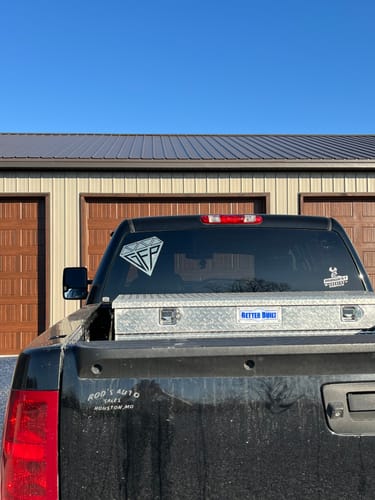 Customer's GFP Diamond Decal applied to the rear window of a black truck, parked outdoors.