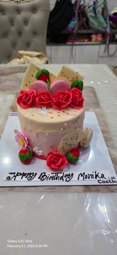Customer's Drippy Macaroon Design Cake, decorated with red roses, pink macaroons, and a 'Happy Birthday Monika' message.