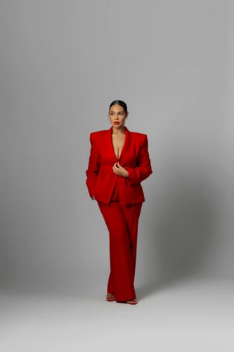 Reviewer wearing the red Suited Sculpted Blazer, showing its structured power shoulders.