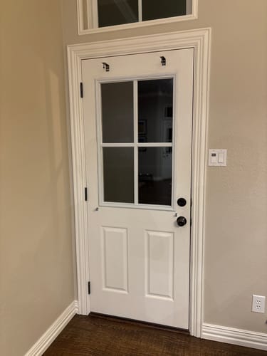 Customer's white door with the Clear 4 Lite Glass and Frame Kit installed in a hallway, showing the final result.