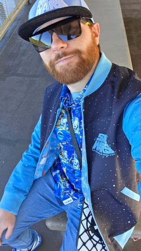 Reviewer showing the blue patterned 'Luke Sleepwalker' shirt styled with a matching Star Wars vest and hat.