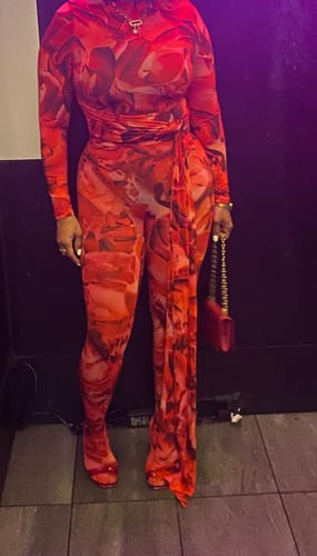 Reviewer wears the red abstract floral Bare Body Boatneck Draped Top with the matching closed toe leggings.