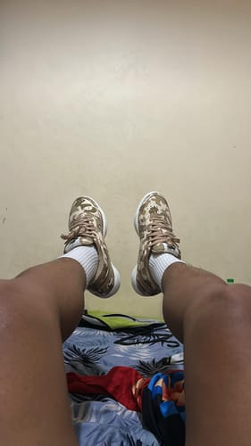 A customer's point-of-view look at their new Nike Book 1 SE EP basketball shoes with a desert camouflage print.