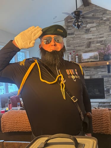 Customer in a military costume with a fake beard, playing a character for the wine tasting murder mystery game.