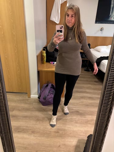 Customer wearing the taupe Sage Ribbed Turtleneck, showing its long fit in a mirror selfie.