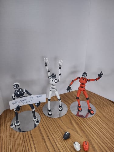 Reviewer's three posable figures in various colors on display, one holding a 'Welcome to the Show' sign.