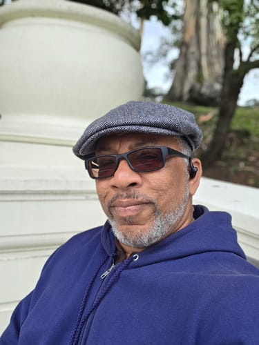 Reviewer wearing a grey textured Wool Newsboy Cap outdoors.