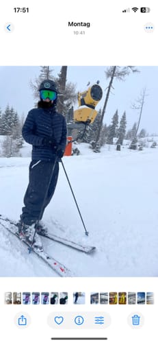 Reviewer skiing in the baggy, waterproof snow pants on a snowy slope.