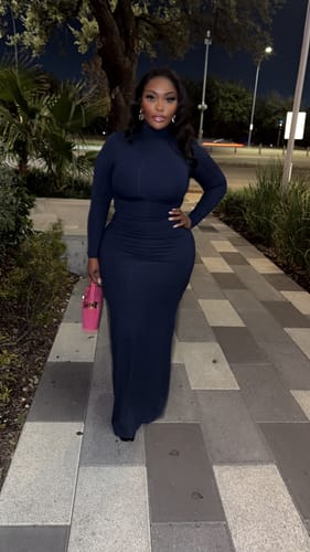 Reviewer posing in the blue Butter Turtleneck Maxi Dress with one hand on their hip.