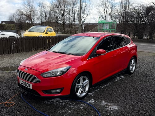 Customer's shiny red car on a gravel driveway after using the New MOAB kit.