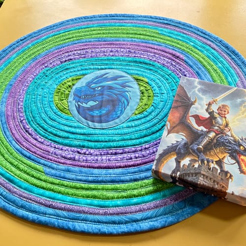 Customer's Storm Dragon Knight portrait next to a colorful, handmade rug that was made to match it.