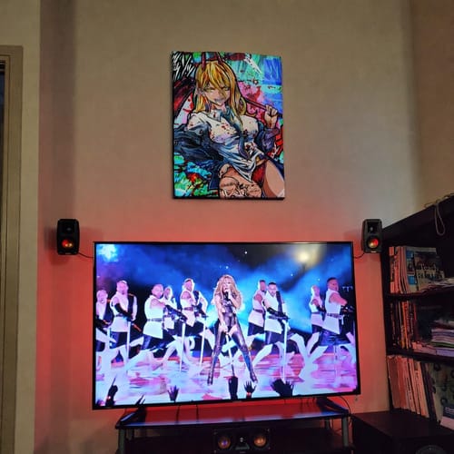 Customer's vibrant Power Chainsaw Man Wall Art hanging on a wall above their home entertainment setup.