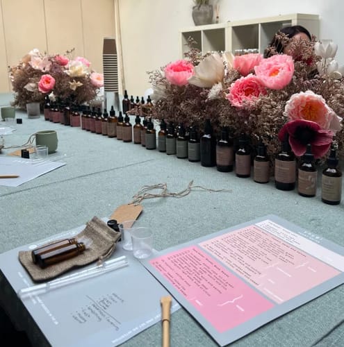 Reviewer's beautifully arranged table at the Perfume Making Workshop, showing essential oil bottles and a personal blending kit.