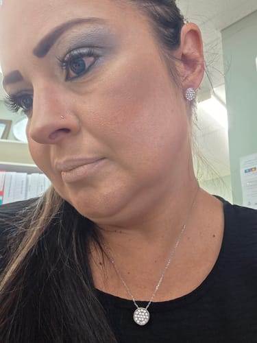 Reviewer wearing the Boxed Pave Necklace and matching stud Earrings against a black top.
