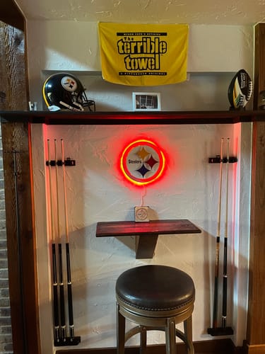 Customer's Pittsburgh Steelers 'Steelmark' wall art illuminated by red LED lights in a game room.