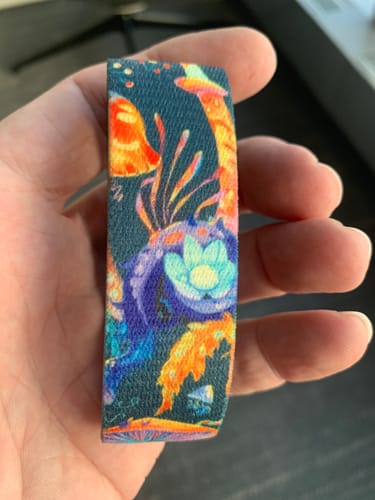 Customer holding the Connected Bracelet, showing the colorful outer mushroom design.
