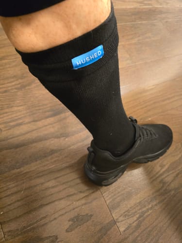 Customer wearing a black Performance Eucalyptus Compression Sock with a matching black sneaker.