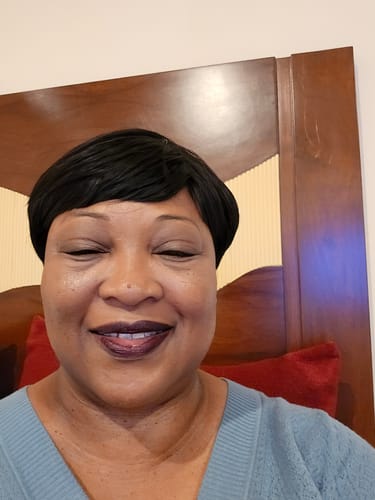Reviewer smiling, showing the natural glow from using The Micro Infusion System.
