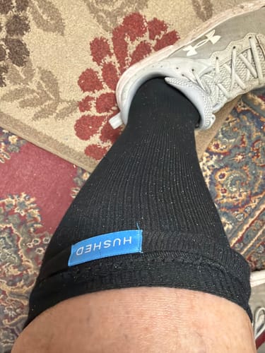 Customer wearing the black Performance Eucalyptus Compression Sock with a grey athletic shoe.