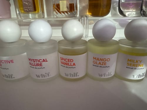 Reviewer's collection of five small Whif perfumes, with the yellow Milky Serene bottle on the right.