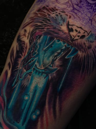 Close-up of a reviewer's colorful cat tattoo in progress after using the Painless Tattoo Numbing Cream.