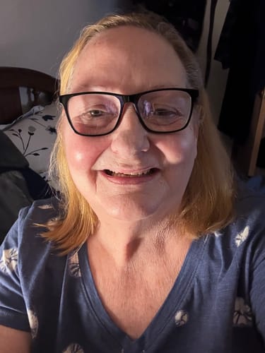 Reviewer smiling in a close-up photo for their product review.