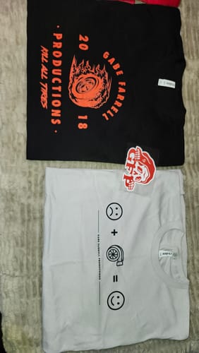 Customer's Bloodline Mystery Box items: a black graphic tee, a white tee with an equation graphic, and a red skull sticker.