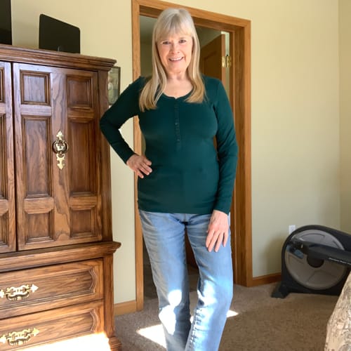 Reviewer standing indoors, showing the fit of the green Reese Ribbed Henley.