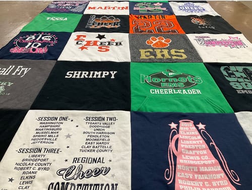Customer's large Premium T Shirt Quilt made from various colorful cheerleading sweatshirts and t-shirts.