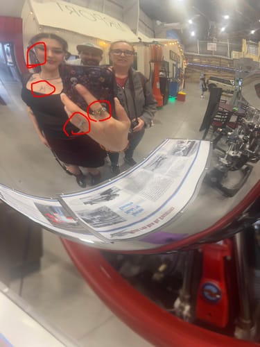 Customer's hand wearing the Promise Ring, seen in a distorted selfie taken in a curved mirror.