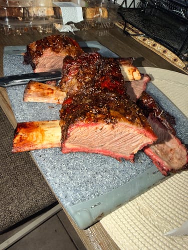 Reviewer's juicy Halal Beef Plate Short Ribs sliced on a cutting board, showing a pink smoke ring.