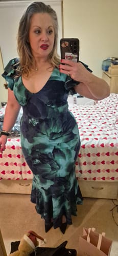 Reviewer taking a mirror selfie wearing the Green Watercolour Floral Maxi Dress, showing its flattering fit.