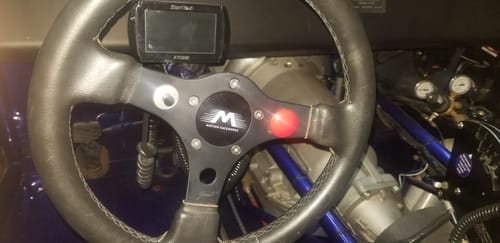 Customer's Motion Raceworks Quick Release Steering Hub installed on the steering wheel inside a race car cockpit.