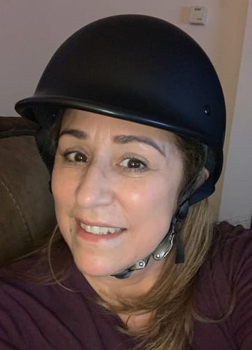 Reviewer smiling while wearing the comfortable, matte black helmet.