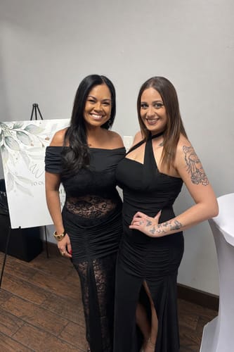 A reviewer on the left wearing the black Valenne Off Shoulder Lace Maxi Dress, showing the sheer lace panel at the waist.