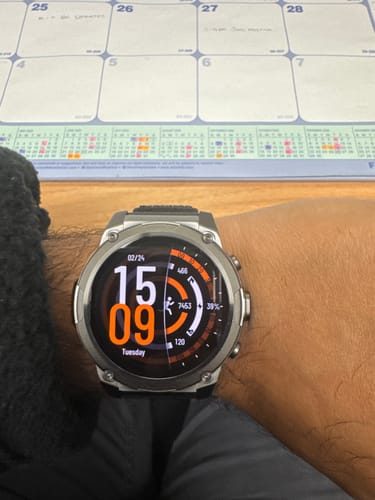 Customer's silver Gard Pro Ultra 3 smartwatch on their wrist, showing the time, battery percentage, and step count on the screen.