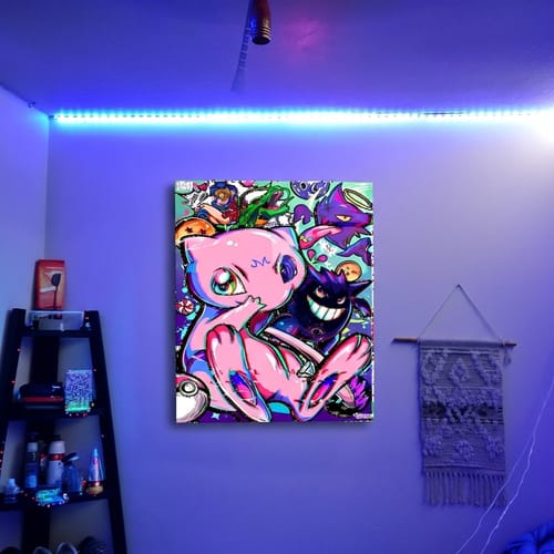 Customer's Renni Mew Wall Art mounted on a wall and illuminated by vibrant blue LED lights in their room.