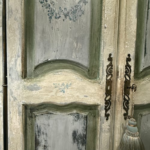 Reviewer's cabinet showing a distressed, antique look in green and cream created with Dark Wax.